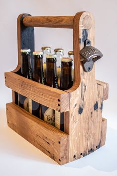 a wooden beer caddy with six bottles in it and a bottle opener on the side