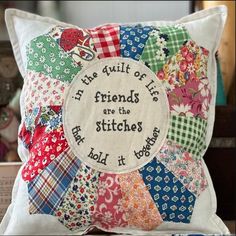 a pillow with a quote on it that says, the quilt of friends are the stitches that hold it together