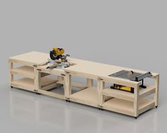 a workbench with a table sawing on it and two shelves holding tools