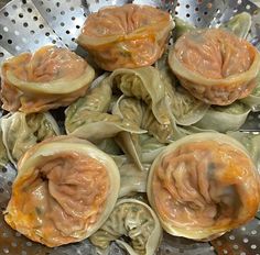 some dumplings are sitting in a metal bowl