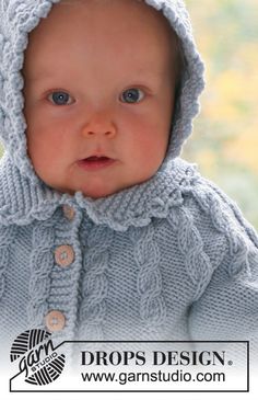 a baby wearing a blue sweater and hood