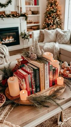 a coffee table with books and candles on it