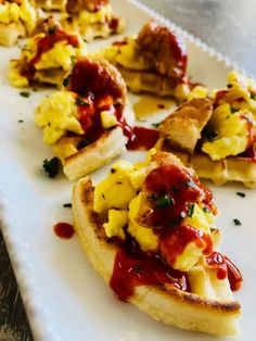 several pieces of bread topped with eggs and ketchup on a white platter