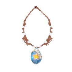 a necklace with a glass bead and an orange star on the front, hanging from a brown cord