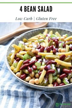 a bowl filled with beans and vegetables on top of a blue checkered table cloth