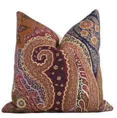 a colorful pillow with an intricate design on the front and back, sitting on a white surface