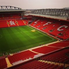 an empty soccer stadium with red seats