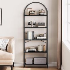 a living room filled with furniture and a book shelf next to a chair in front of a window