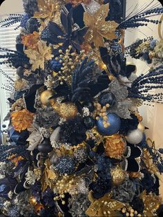 a christmas tree with blue and gold decorations