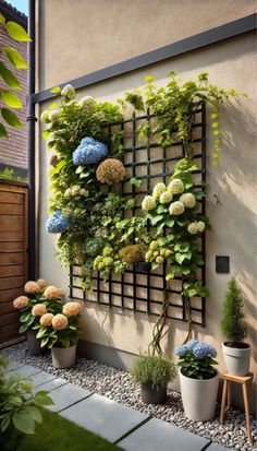 an outdoor garden with flowers and plants on the wall