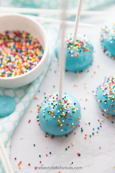 blue cake pops with sprinkles on them