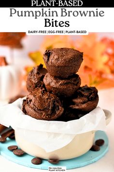 chocolate pumpkin brownie bites stacked on top of each other in a blue and white bowl