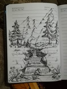 an open notebook with some drawings on it, and trees in the backgroud