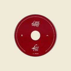 a red cd disc with the words lost tree written in white ink on it's side