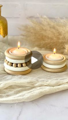 three wooden candles sitting on top of a table