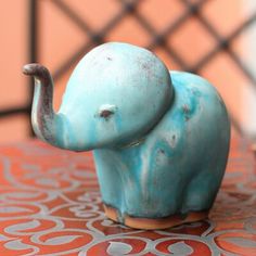 an elephant figurine sitting on top of a table