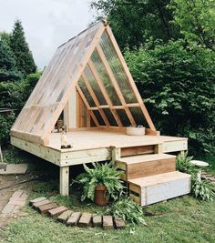 a small wooden structure with stairs leading up to it