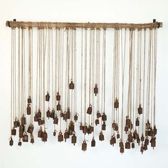 a group of bells hanging from the side of a wall