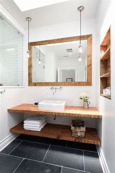 a bathroom with a sink, mirror and shelves