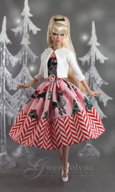 a barbie doll wearing a red and white dress with christmas trees in the back ground