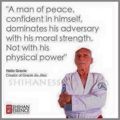 an old man in karate gear with a quote on the front and back of his shirt