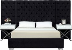 a bed with two nightstands and a black headboard on it's side