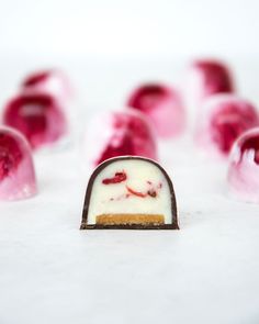 a piece of cake sitting on top of a white table next to other desserts