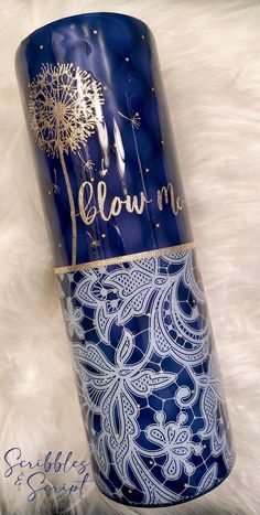 a blue and white can with a dandelion on it sitting on a furnishing