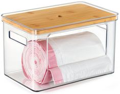 a clear plastic container holds two rolls of toilet paper and a bamboo board on top