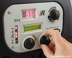 a person adjusting the time on an old radio