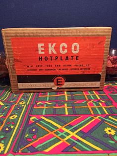 a colorful table cloth with the words ecco hotplate on it and candles in front