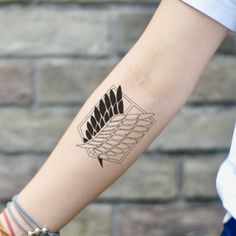 a woman's arm with a tattoo on it and an arrow in the middle