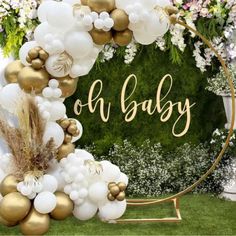 a baby sign surrounded by balloons and flowers