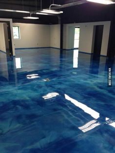 an indoor swimming pool with blue paint on the floor