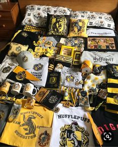 a bed covered in harry potter shirts and other items from the hogwarts movies