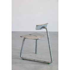 a metal chair sitting on top of a cement floor