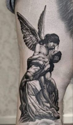 a man with an angel tattoo on his arm