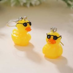 two yellow rubber ducks with sunglasses on them