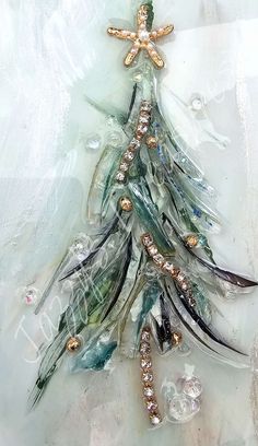 a glass ornament with a christmas tree made out of beads and other items