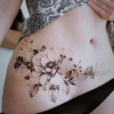 a woman with a flower tattoo on her stomach