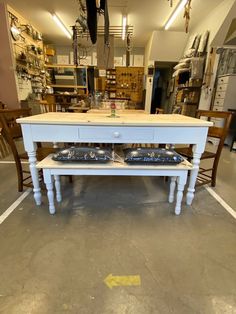 a table with two trays on it in a room filled with tools and other items