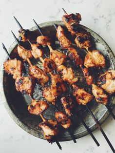 chicken skewers on a plate with toothpicks