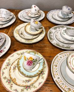 a table topped with lots of plates and cups