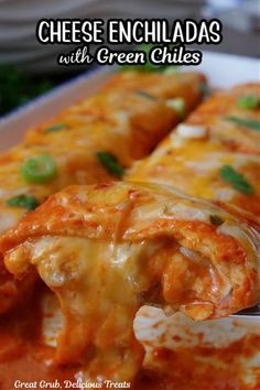 cheese enchiladas with green chiles on a white platter being held by a fork