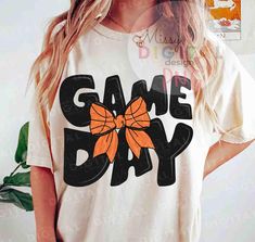 a woman wearing a game day shirt with an orange bow