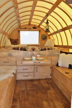 the inside of a small wooden cabin with wood flooring