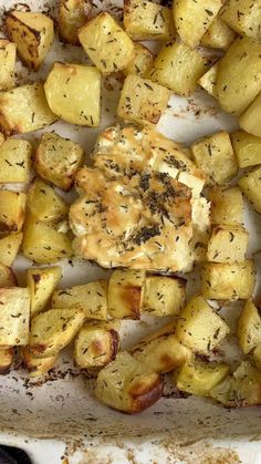 cooked potatoes with herbs and seasoning in a baking dish, ready to be eaten