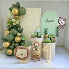 a baby's first birthday party with balloons, decorations and animals on the floor