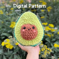 a hand holding an avocado stuffed animal in it's right hand with the words digital pattern above it