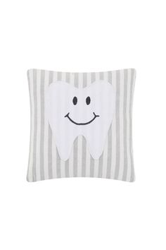 a tooth pillow with a smile on it